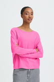 Woman wearing a bright pink long-sleeve top against a white background