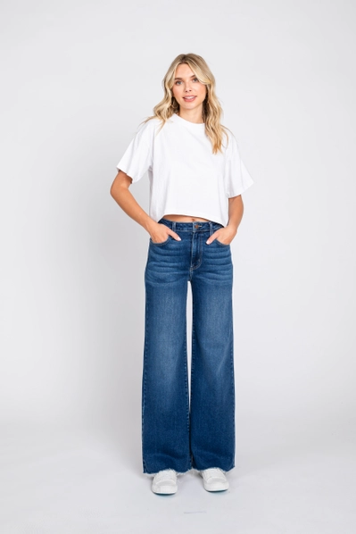 Woman wearing a white t-shirt and blue jeans on a white background