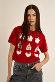 woman in red, patterned sweater against white background