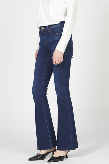 Person wearing blue jeans and a white top on a white background