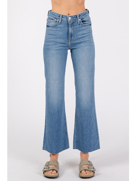 Blue jeans worn by a person on a white background