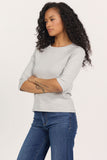 woman in grey, 3/4 sleeve top and jeans