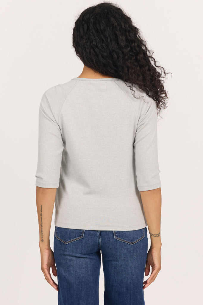 back of woman in grey, 3/4 sleeve top and jeans