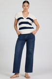 Woman wearing a striped shirt and blue jeans on a white background