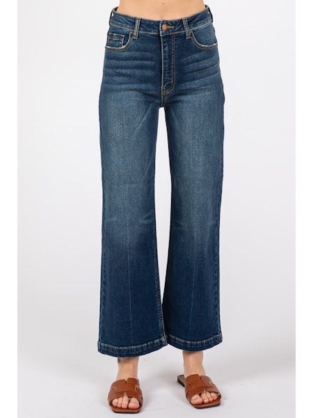 Blue jeans worn by a person on a white background