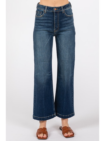 Blue jeans worn by a person on a white background