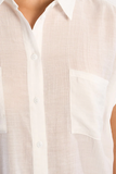 Close-up of a beige button-up shirt with a pocket
