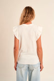 Person wearing a white t-shirt and light blue jeans on a beige background